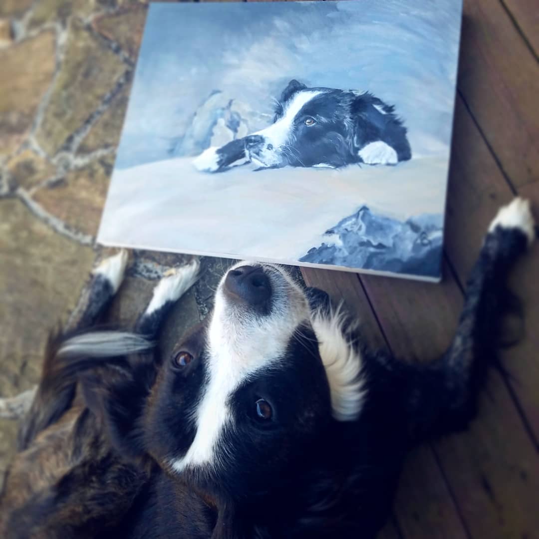 A dog sitting beside his oil painting pet portrait by Melissa Garner